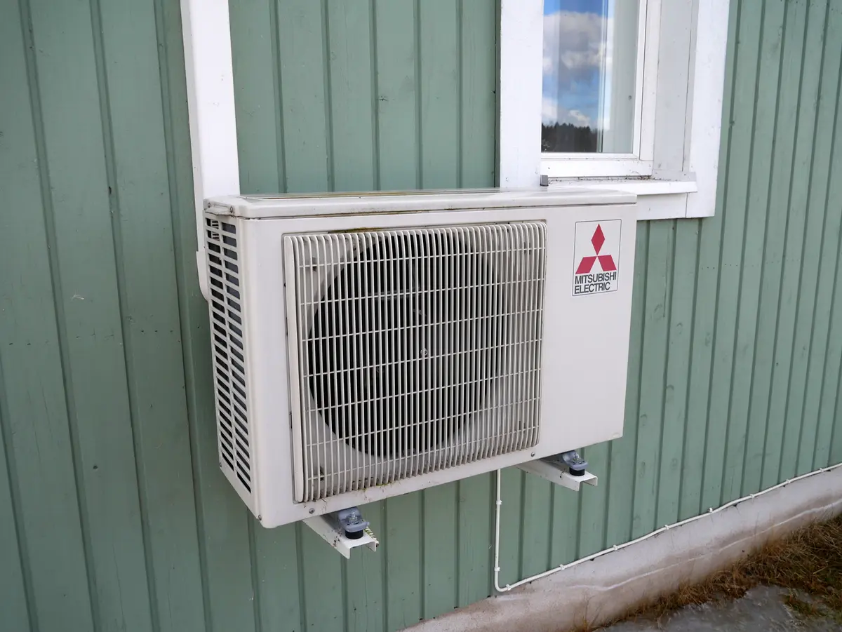 Buitenunit van een lucht-waterwarmtepomp aan een gevel